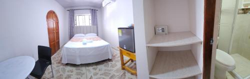 a small room with a small table and a sink at Caribbean Airport Hotel in Cartagena de Indias