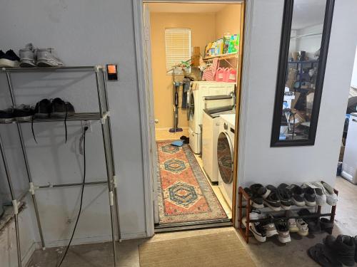 a hallway with a laundry room with a washer and dryer at Goodyear 2 Story Room 4 in Goodyear