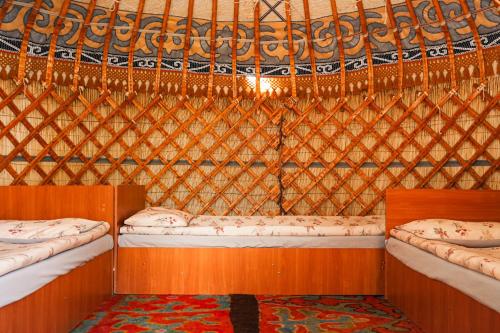 a room with two bunk beds in a yurt at Yurt camp Meiman Ordo in Bokonbayevo