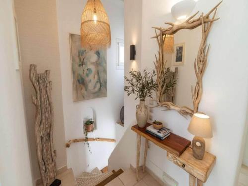 a room with a table and some branches on the wall at Mykonos Villa for 8 with Pool in Mikonos