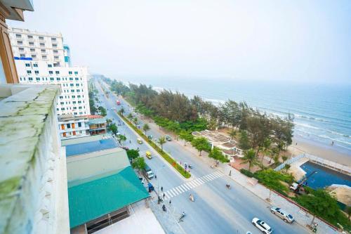 an aerial view of a beach with a building and the ocean at Ks sơn trang 1 in Sầm Sơn