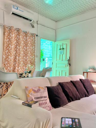 a living room with a couch and a door at Maculusso Hidden Gem Central & Comfortable Apartment in Luanda