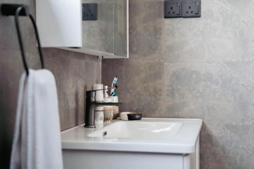 a bathroom with a white sink and a towel at Rockvin BnB in Midigama East