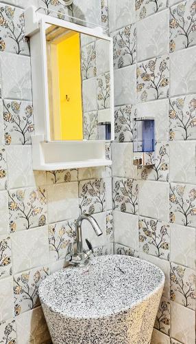 a bathroom with a sink and a mirror at Satkarma in Rishīkesh