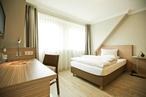 A bed or beds in a room at Boutiquehotel Myn Utspann