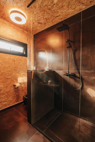 a bathroom with a shower with a sink and a shower at Secluded design cabin forest retreat in Cyprus in Kappedhes