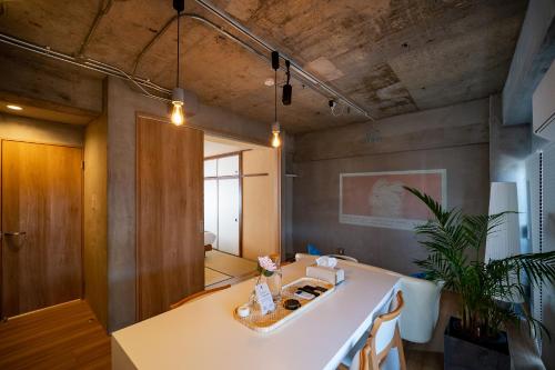 a bathroom with a white sink in a room at Shiki Villa Beppu in Beppu