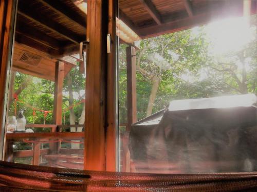 a window of a house with a view of a patio at YOISAMA Sunrise Beach House in Ishigaki Island
