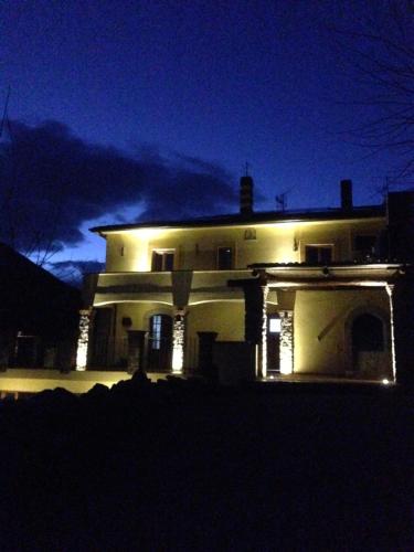 a large white house with lights in the dark at Locanda Marzi in Faicchio