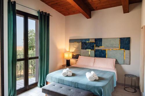 a bedroom with a bed and a large window at B&B Tra mare e montagna - sauna e piscina in San Giorgio di Pesaro