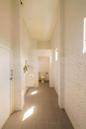 a bathroom with a yellow toilet in a room at Happy Bear Hostel Phu Quoc in Phú Quốc