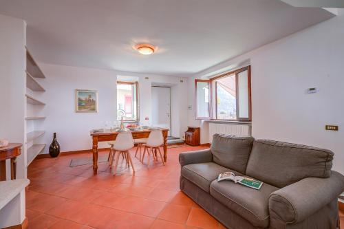 a living room with a couch and a table at Casa al Castello in Leggiuno with Garden - Happy Rentals in Leggiuno
