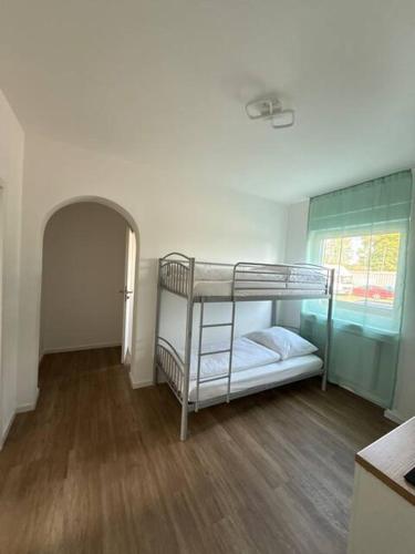 a room with two bunk beds and a window at Am Silbersee in Hochheim am Main
