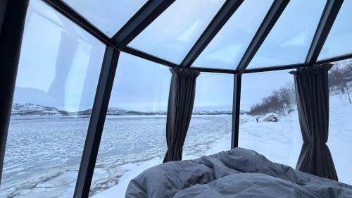 a view from inside a igloo in the snow at Aurora Sea Lodges AURORAHUT in Herjenes