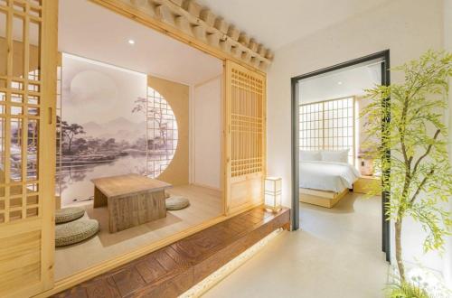 a bedroom with a bed and a table in a room at Yeonhwamoon Hotel Yangyang in Yangyang