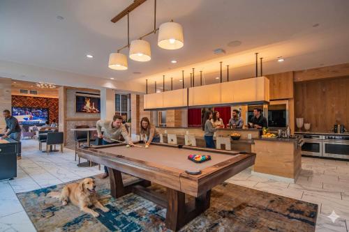 a group of people in a kitchen with a pool table at Bright 1BR Uptown Biltmore Gym Pool Parking WD in Phoenix