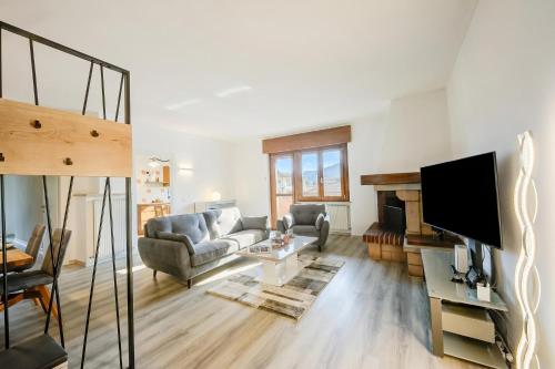 a living room with a couch and a tv at Casa Alexander - Lake Garda Apartment with Terrace - Happy Rentals in Riva del Garda