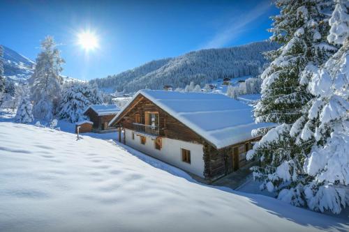 a log cabin in the snow in the mountains at Chalet Backflip - OVO Network in La Clusaz