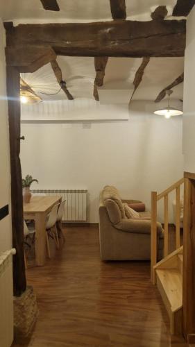 a living room with a couch and a table at Casa Rural Doña Aba in Espinosa de los Monteros