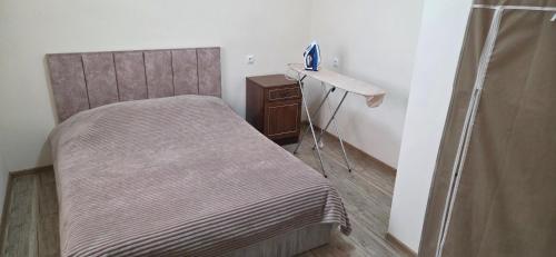 a small bedroom with a bed and a desk at Hasmik house in Areni