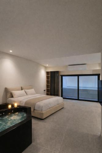 a bedroom with a large bed and a swimming pool at Andromeda Suite Private Jacuzzi & Cave Shower in Athens