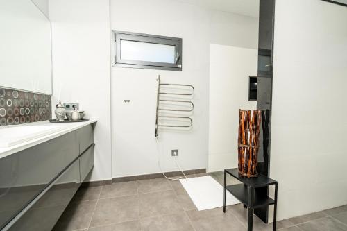 a kitchen with white walls and a black table at Azahar Sun in Ondara