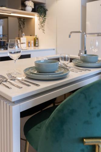 a table with two plates and wine glasses on it at Matcha Madness Zen Escape - Riverfront in Brisbane