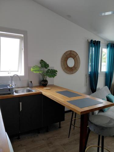 a kitchen with a sink and a wooden counter top at Papaya in Noumea