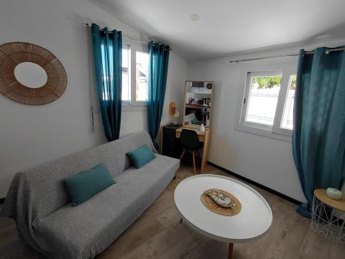 a living room with a couch and a table at Papaya in Noumea
