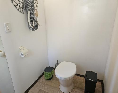 a small bathroom with a toilet in a room at Clouds Serenity in Beechmont