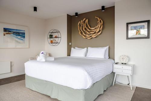 a bedroom with a large bed with a white bedspread at Elevation in Bicheno