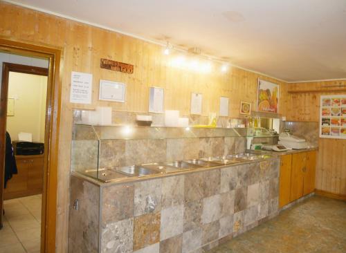 a kitchen with a bunch of sinks on a wall at Kensal Green Backpackers 2 in London