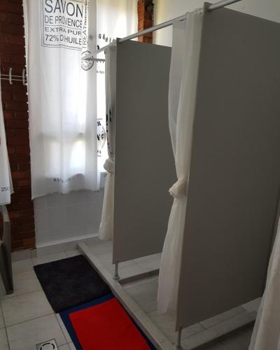 a bathroom with a shower stall and a window at Berek Szálló in Balatonfenyves
