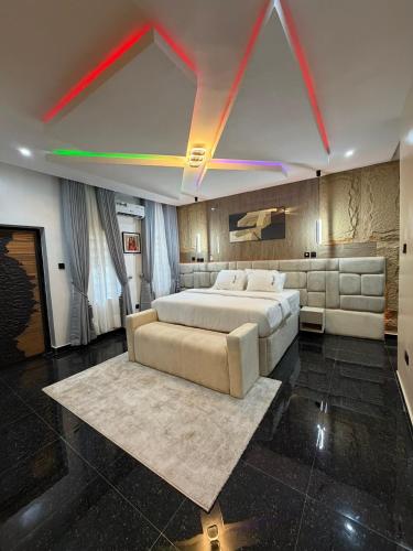 a bedroom with a large bed and a couch at House 9 Signature in Port Harcourt