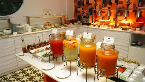 a display of drinks in jars on a table at Hennessy Park Hotel in Ebene