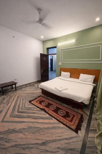 a bedroom with a large bed and a rug at Heritage Inn in Lucknow