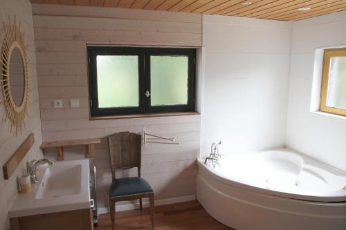 a bathroom with a tub and a sink at Le Chalet de Merlimont in Merlimont