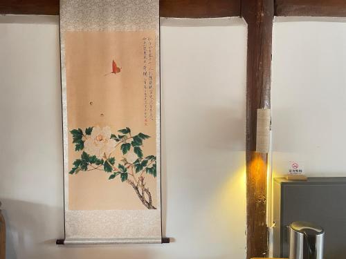a picture of a bird on a wall at Baisha Holiday Resort Lijiang in Lijiang