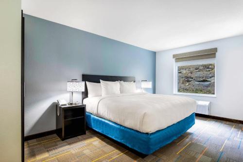 a bedroom with a large bed and a window at MainStay Suites Winfield-Teays Valley in Hurricane