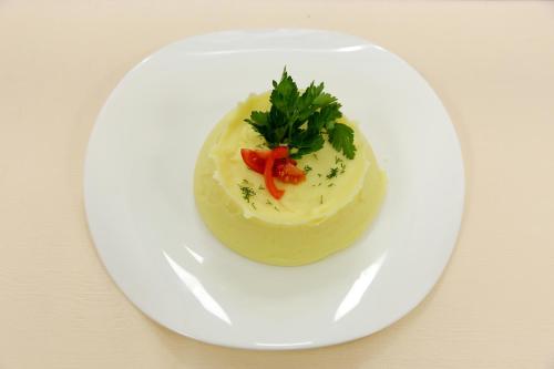 a white plate with a piece of food on it at BeSt Hotel and Restaurant complex in Dunaivtsi