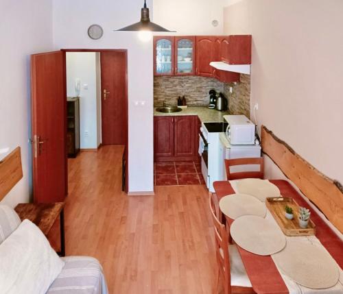 a kitchen with a table and a kitchen with a counter at Apartmán Simi, Karlovice 251, 79323 Karlovice in Karlovice