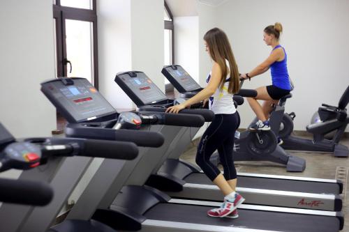 two women running on a treadmill in a gym at BeSt Hotel and Restaurant complex in Dunaivtsi