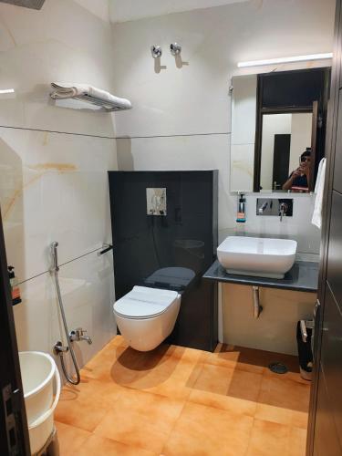 a bathroom with a toilet and a sink and a mirror at Hotel Tara Palace, Chandni Chowk in New Delhi