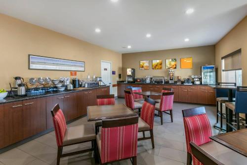 a restaurant with tables and chairs and a counter at Comfort Inn Fort Collins North in Fort Collins