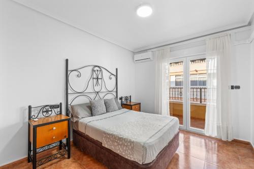 a bedroom with a bed and a large window at Zoa in Torrevieja