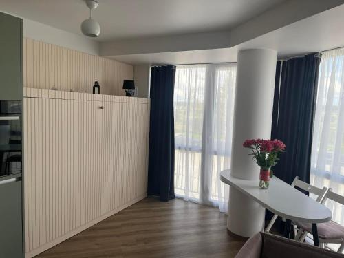 a living room with a white table and a window at Breeze Studio in Palanga
