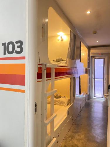 a room with a wall with a fire truck at Charlie's Hangar Surf Hostel in San Juan