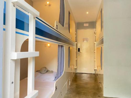 a room with bunk beds and a hallway at Charlie's Hangar Surf Hostel in San Juan