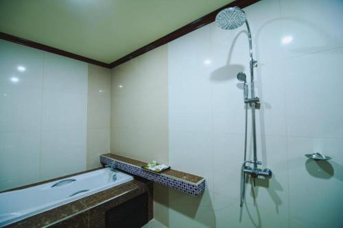 a bathroom with a shower and a sink at AmornSukhothai Hotel in Sukhothai