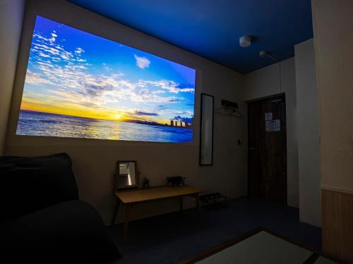 a room with a window with a view of the ocean at WE HOME HOTEL and KITCHEN 市川 船橋 in Ichikawa